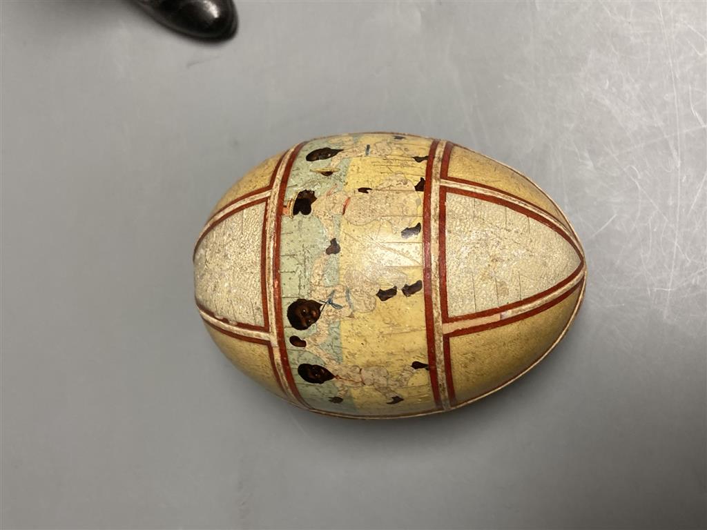 An early 20th century leather decorated easter egg, a pair of 19th century miniature ladies boots and a magic lantern Puss in Boots